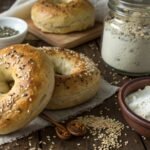 Sourdough bagels next to regular bagels on a rustic table, showcasing their unique textures and flavors